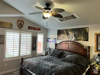 Bedroom with multiple windows, ceiling fan, and vaulted ceiling