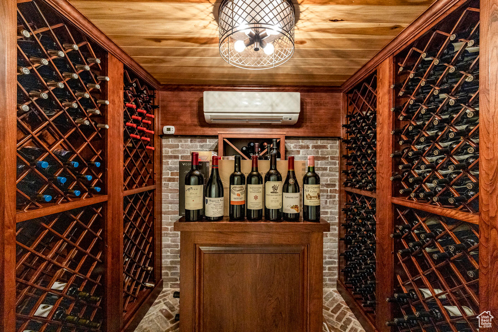 Wine room with a wall unit AC, brick wall, and wooden ceiling