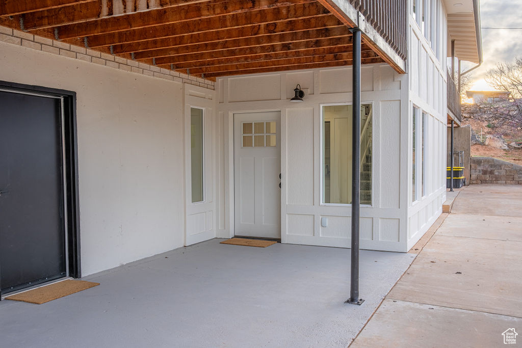 Doorway to property with a patio area