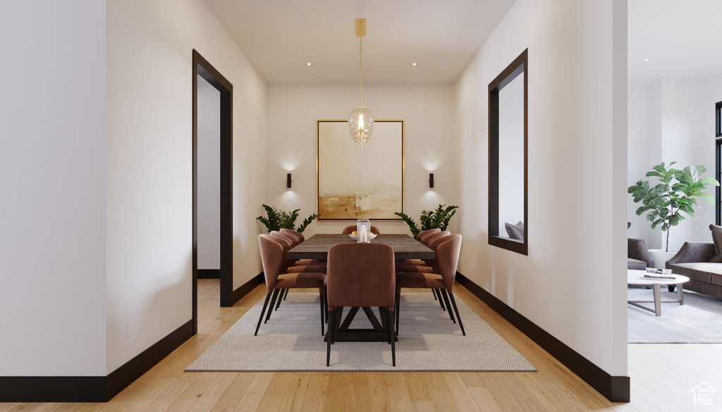 Dining area featuring light hardwood / wood-style flooring and an inviting chandelier