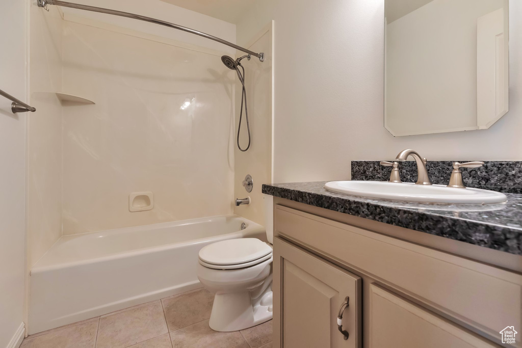 Full bathroom with  shower combination, toilet, vanity, and tile flooring