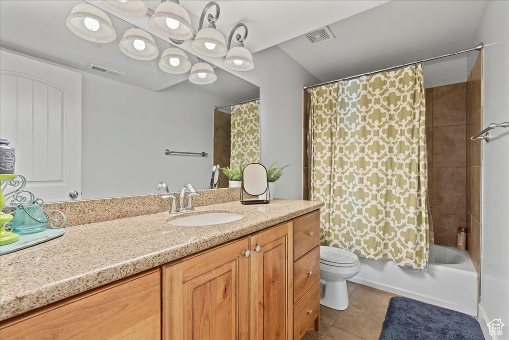 Full bathroom with toilet, shower / bathtub combination with curtain, tile floors, and vanity
