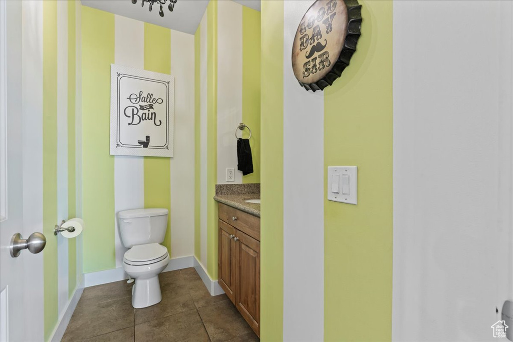 Bathroom featuring tile floors, toilet, and vanity