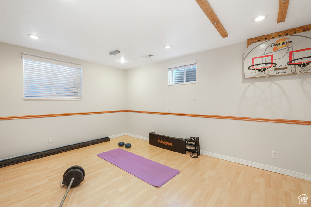 Workout area with light hardwood / wood-style flooring