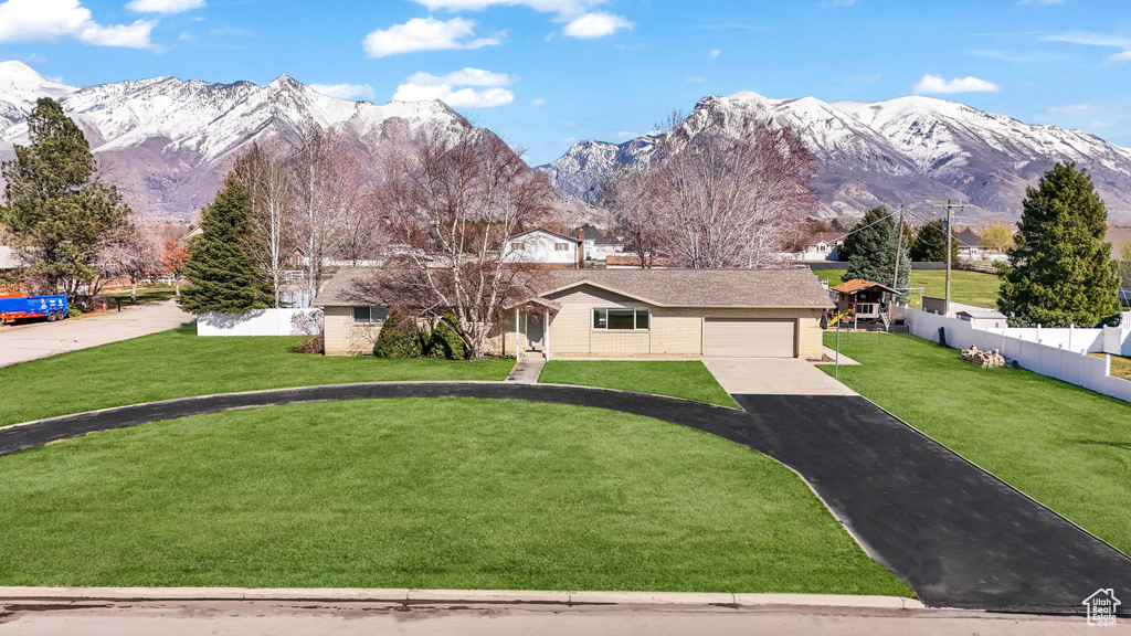 View of front of property with a front lawn and a mountain view