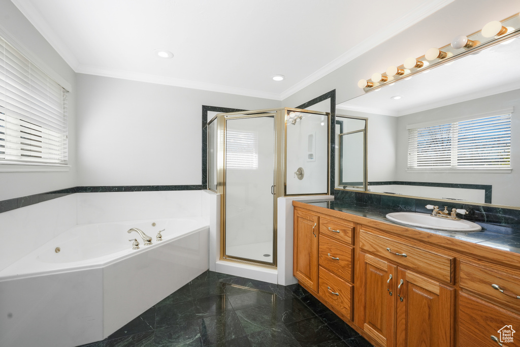 Bathroom featuring tile floors, oversized vanity, ornamental molding, and independent shower and bath