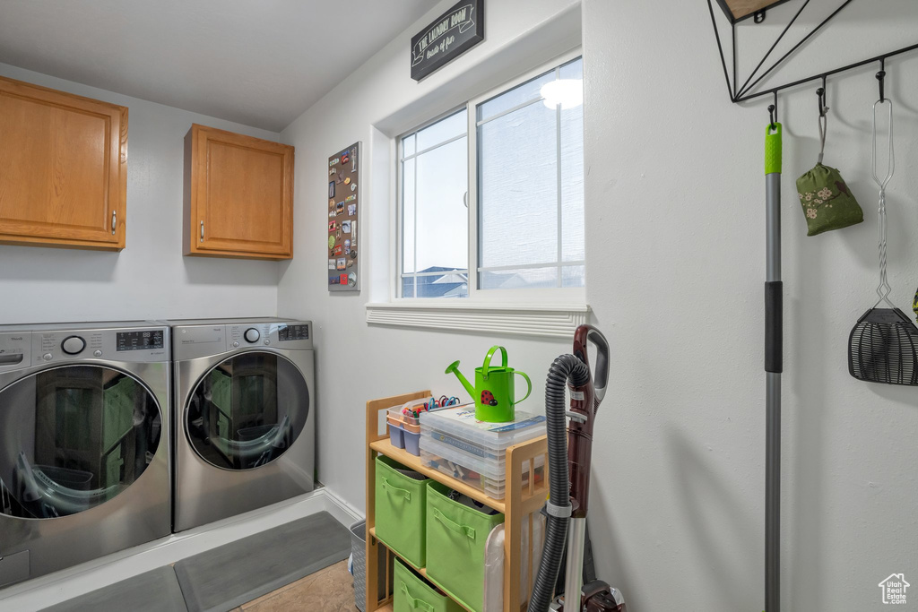 Laundry area with washing machine and dryer and cabinets