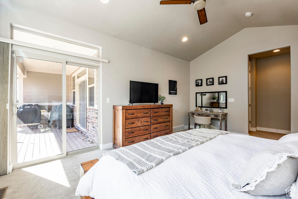 Carpeted bedroom featuring ceiling fan, access to outside, and lofted ceiling