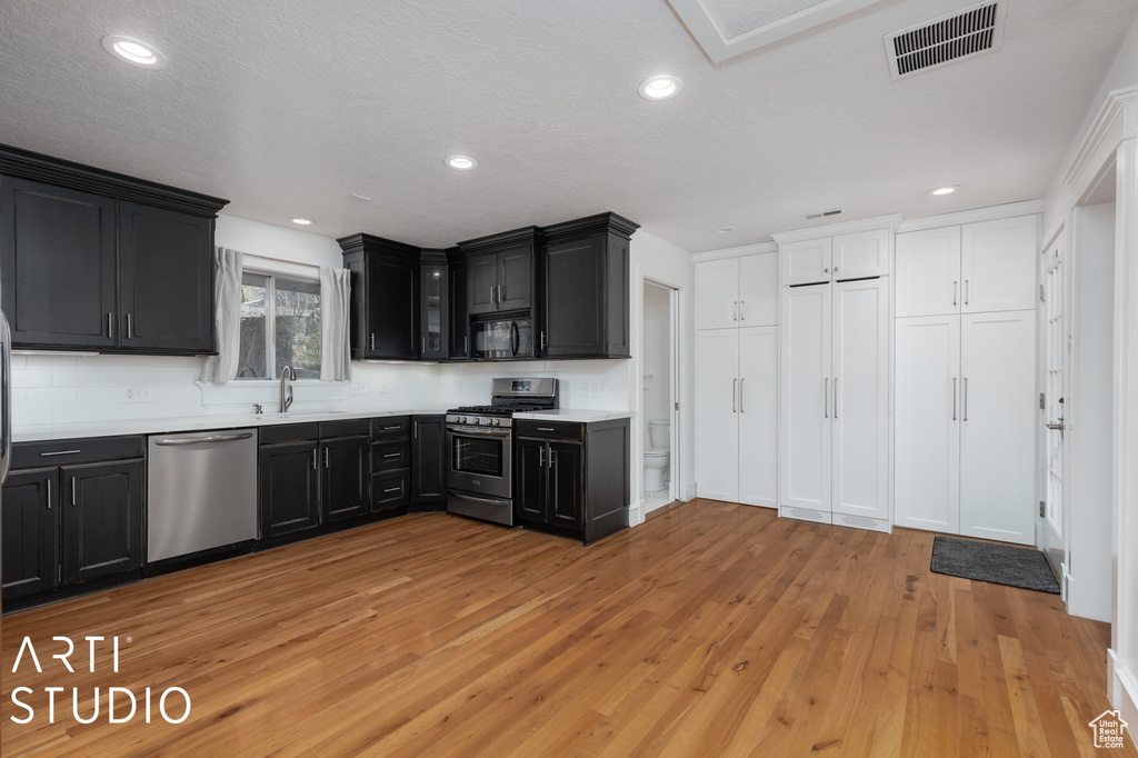Kitchen featuring sink, stainless steel appliances, and light hardwood / wood-style floors