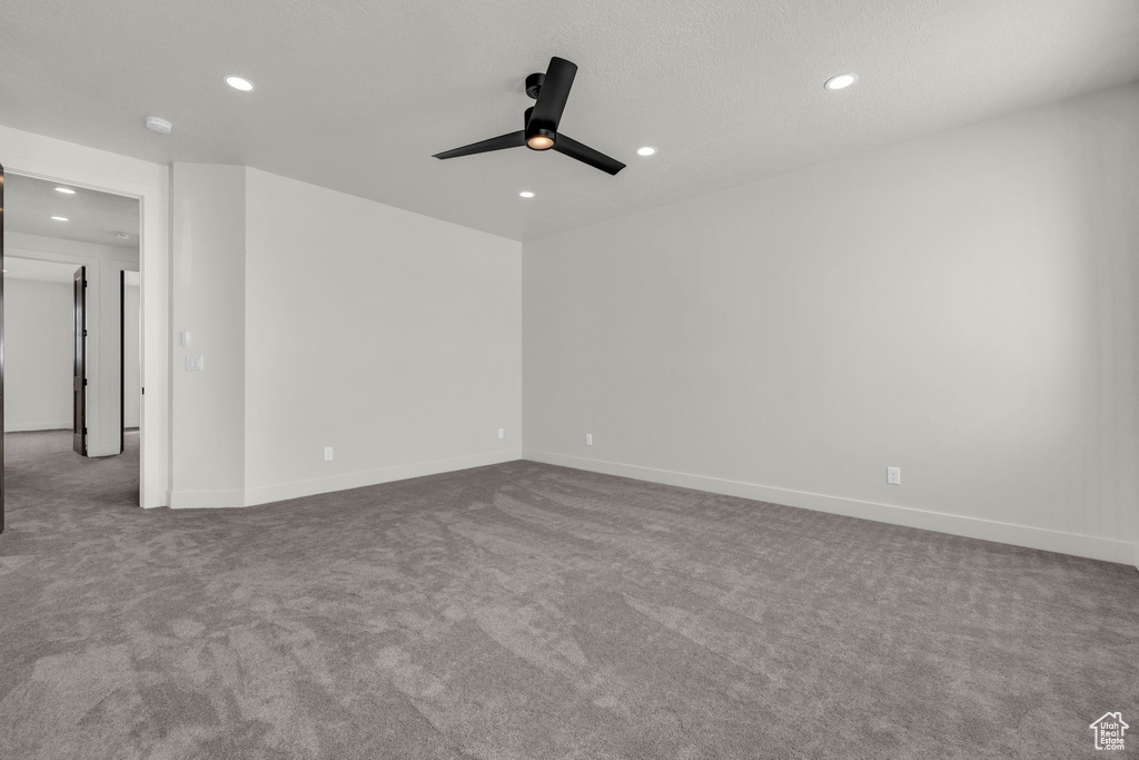Empty room featuring ceiling fan and light colored carpet