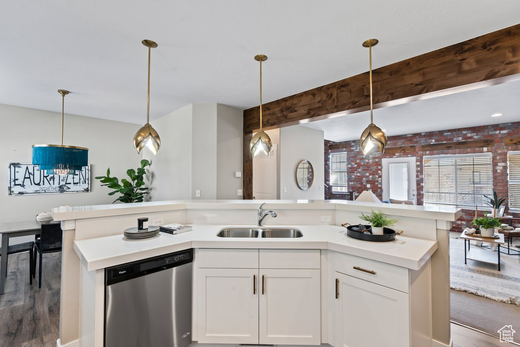 Kitchen featuring hanging light fixtures, sink, hardwood / wood-style floors, and dishwasher