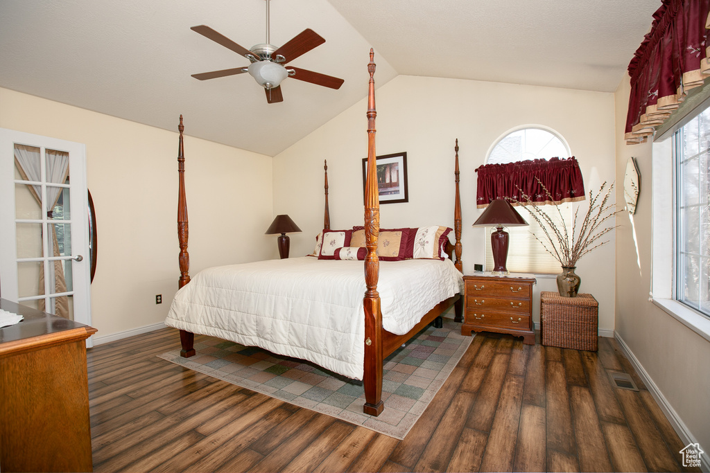 Bedroom with multiple windows, lofted ceiling, dark wood-type flooring, and ceiling fan