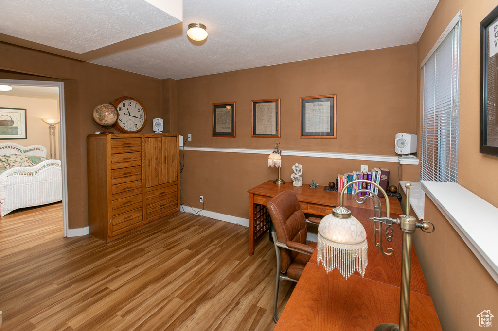 Office area with light hardwood / wood-style flooring