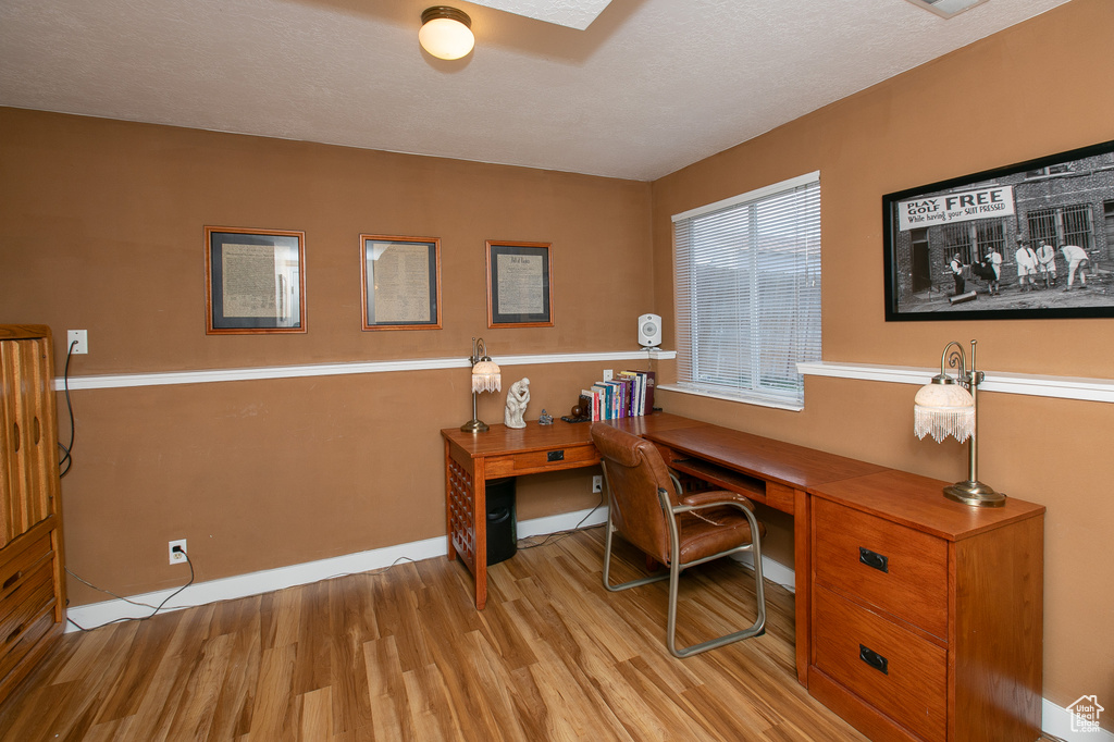 Home office featuring light hardwood / wood-style flooring