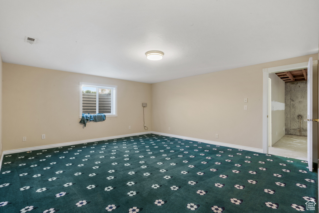 Spare room with dark carpet