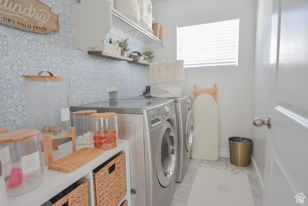 Laundry area featuring hookup for a washing machine, light tile flooring, and washer and clothes dryer