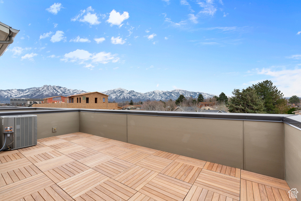 Wooden terrace with a mountain view and central AC unit