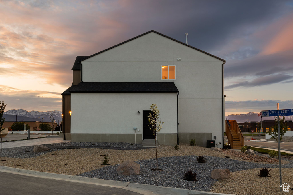 Property exterior at dusk with a mountain view