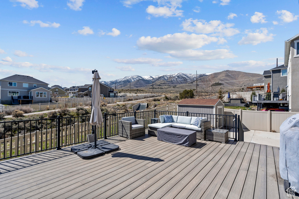 Wooden deck with an outdoor living space and a mountain view