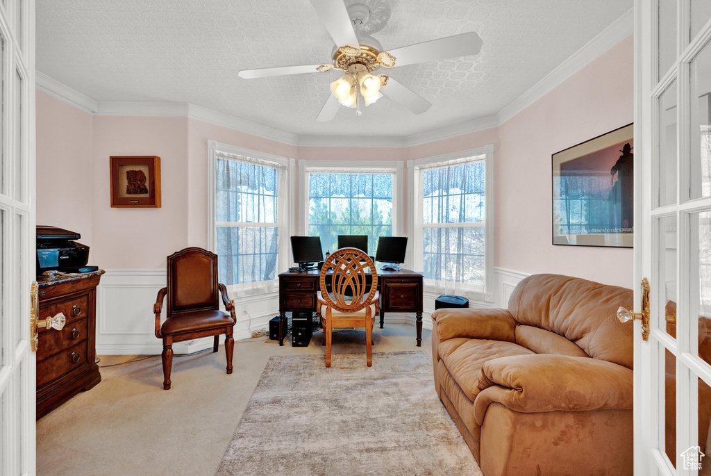 Office with ceiling fan, a textured ceiling, french doors, ornamental molding, and light carpet