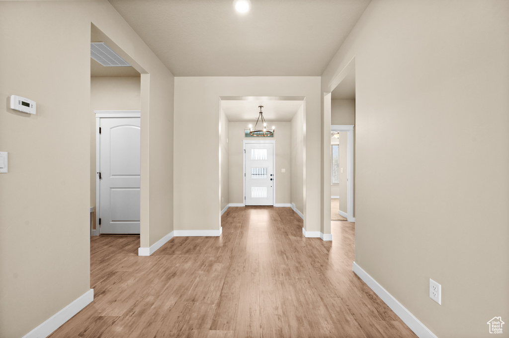 Entryway featuring a notable chandelier and light hardwood / wood-style floors