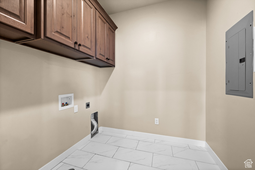 Laundry room featuring washer hookup, cabinets, electric dryer hookup, and light tile floors