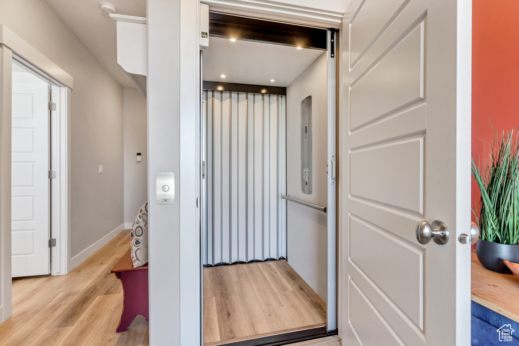 Interior space featuring elevator and light hardwood / wood-style floors