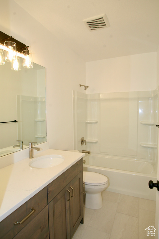 Full bathroom featuring vanity, tile flooring, shower / bathtub combination, and toilet