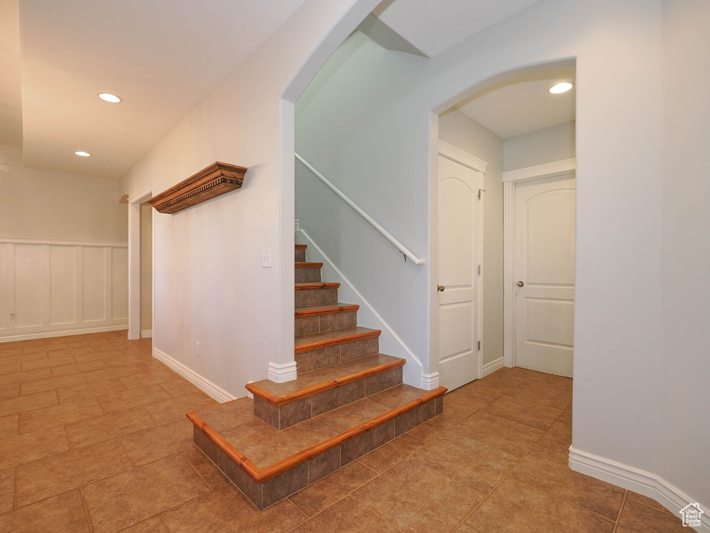 Staircase with light tile flooring