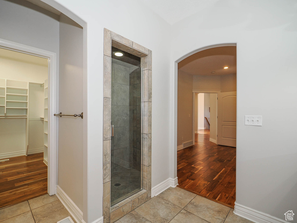 Bathroom featuring an enclosed shower and tile flooring