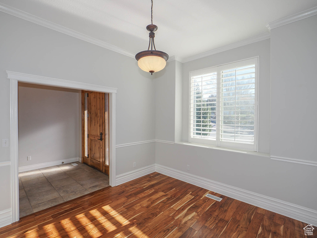 Unfurnished room featuring dark hardwood / wood-style floors and ornamental molding
