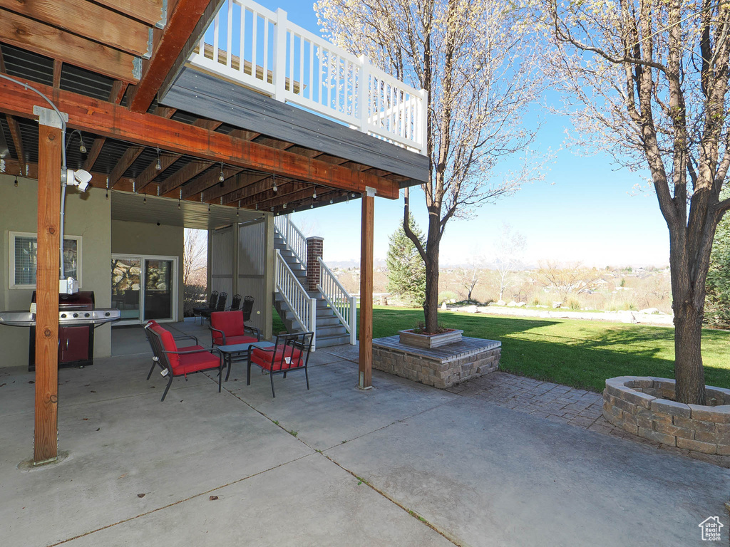 View of patio / terrace featuring a wooden deck and ceiling fan