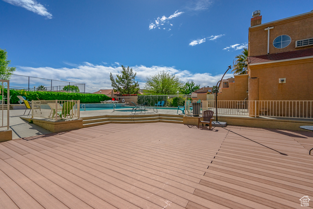 Wooden deck featuring a community pool