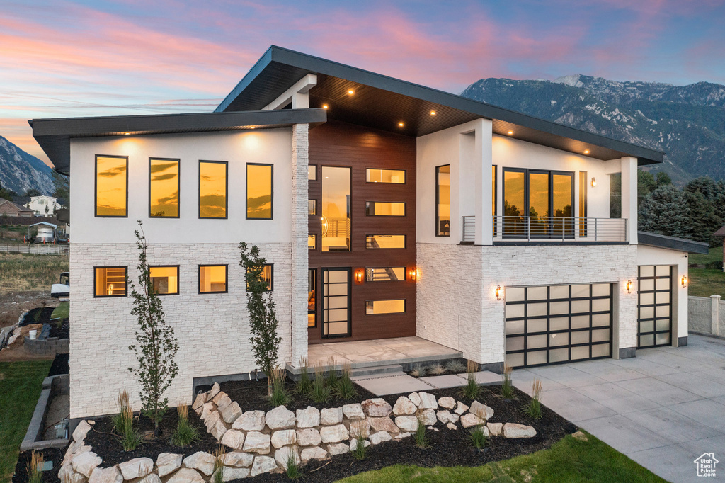 Contemporary home with a mountain view and a garage