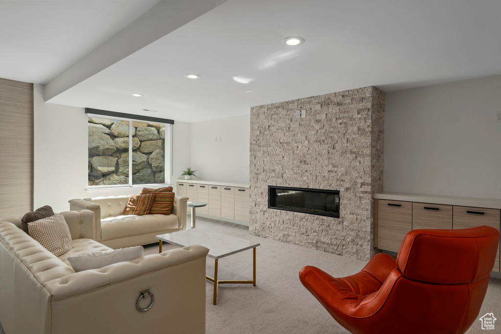 Living room with a fireplace and light colored carpet