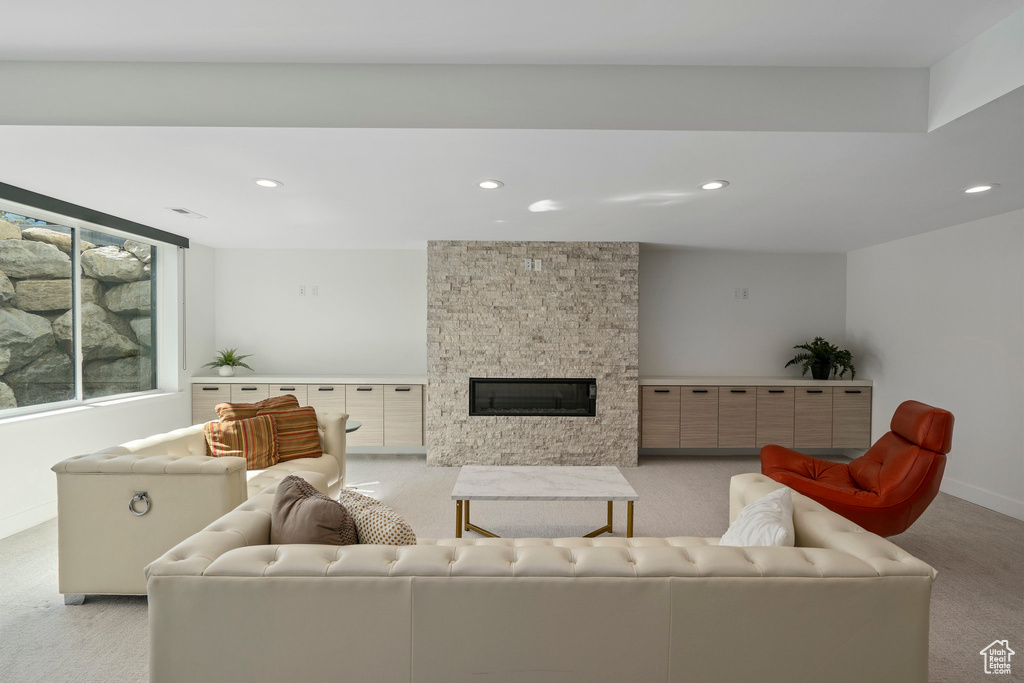 Living room with light colored carpet and a fireplace