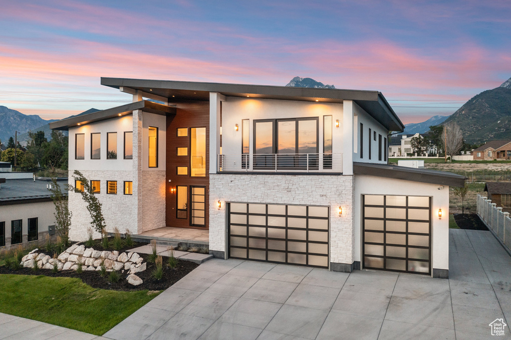 Contemporary house featuring a mountain view and a garage