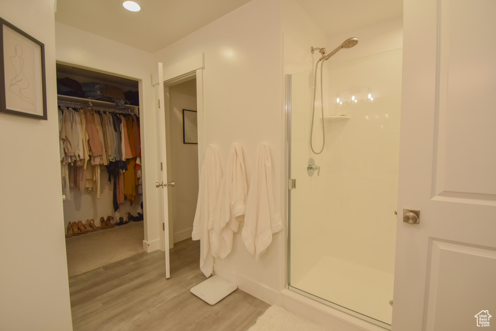 Bathroom featuring a shower with door and hardwood / wood-style floors