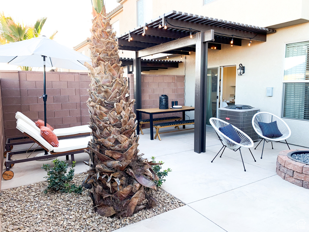 View of terrace with a pergola, central AC, and an outdoor fire pit