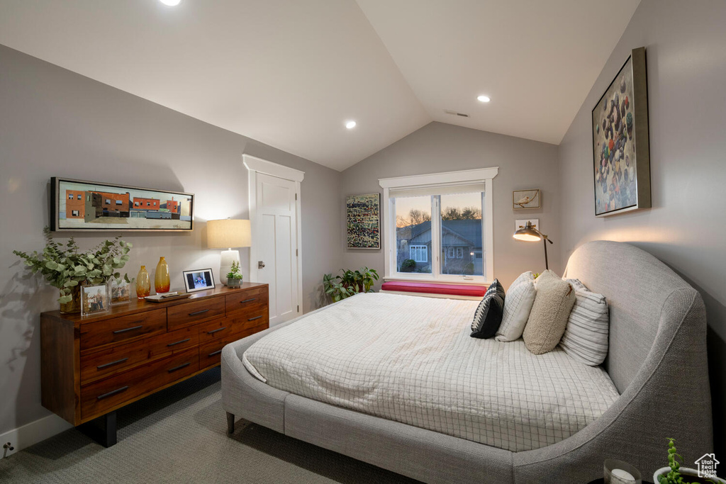 Bedroom featuring carpet floors and vaulted ceiling