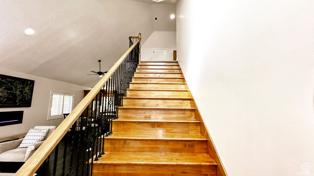 Stairway featuring ceiling fan