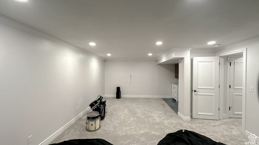 Interior space featuring light carpet and crown molding