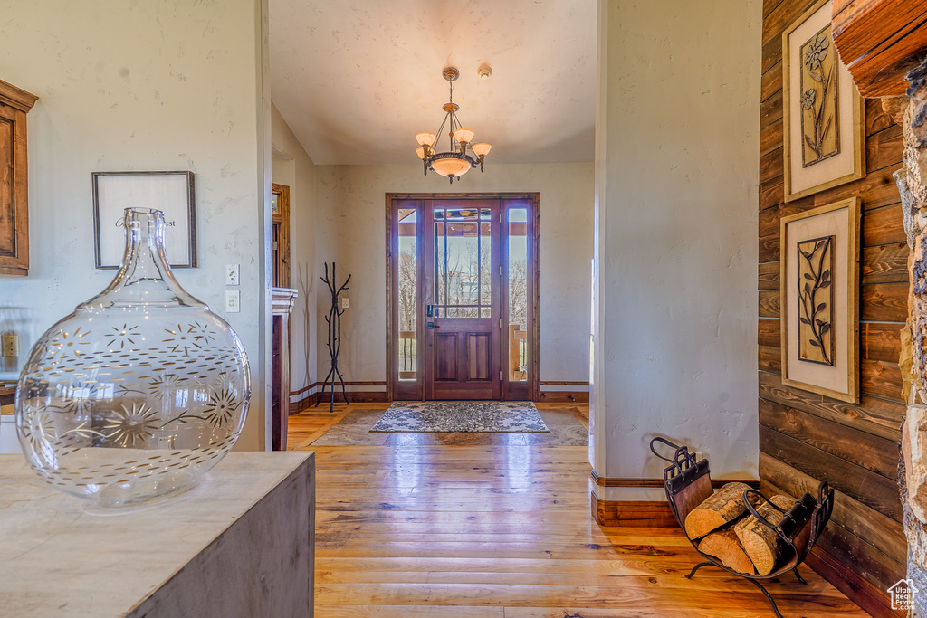 Entryway featuring a notable chandelier and light hardwood / wood-style floors