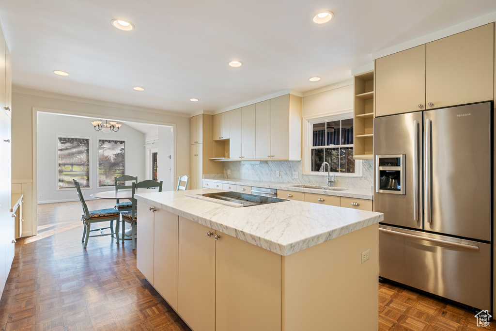 Kitchen featuring stainless steel fridge, dark parquet floors, a kitchen island, and cream cabinets