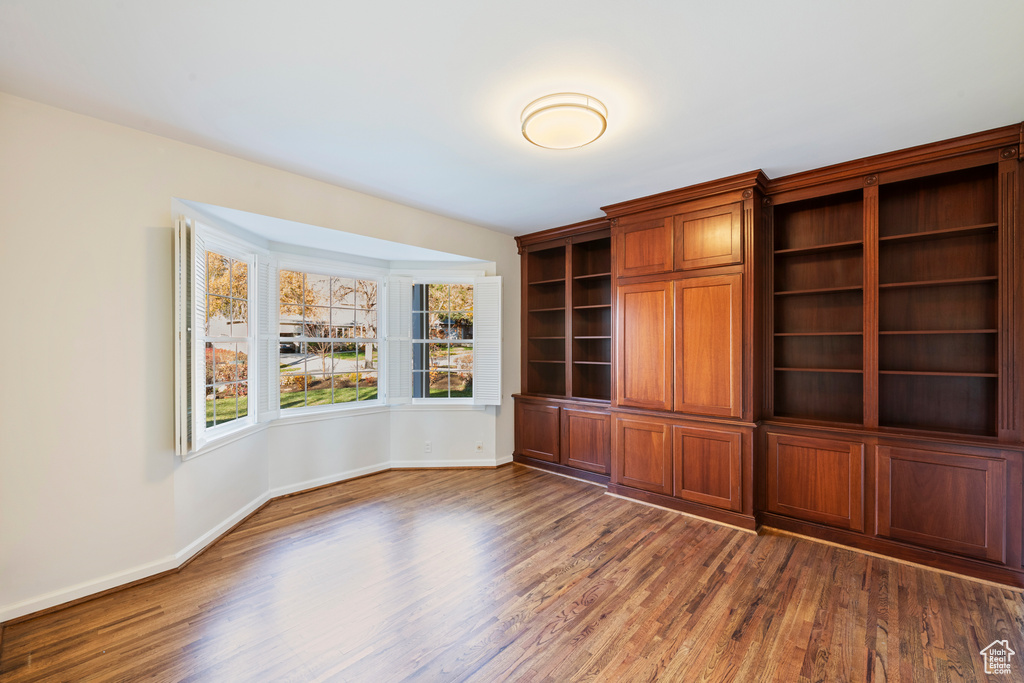 Unfurnished office with dark hardwood / wood-style flooring