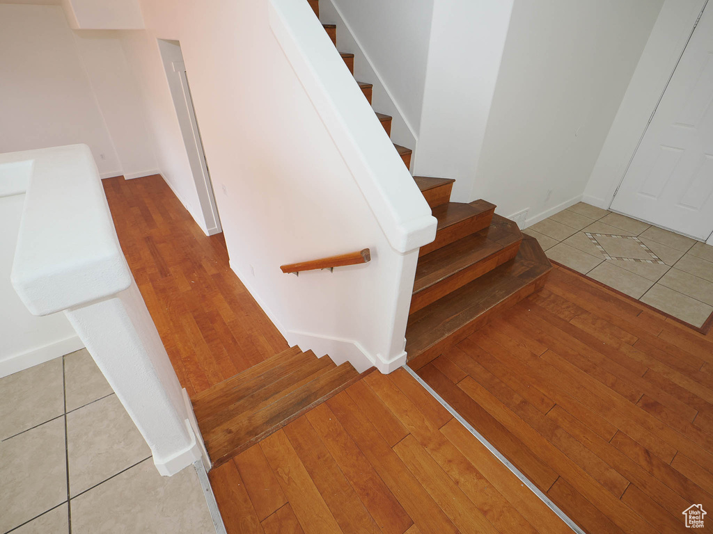 Stairway featuring light tile floors