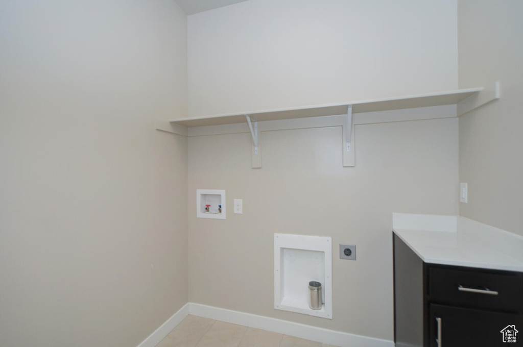 Laundry area with light tile flooring, electric dryer hookup, and hookup for a washing machine