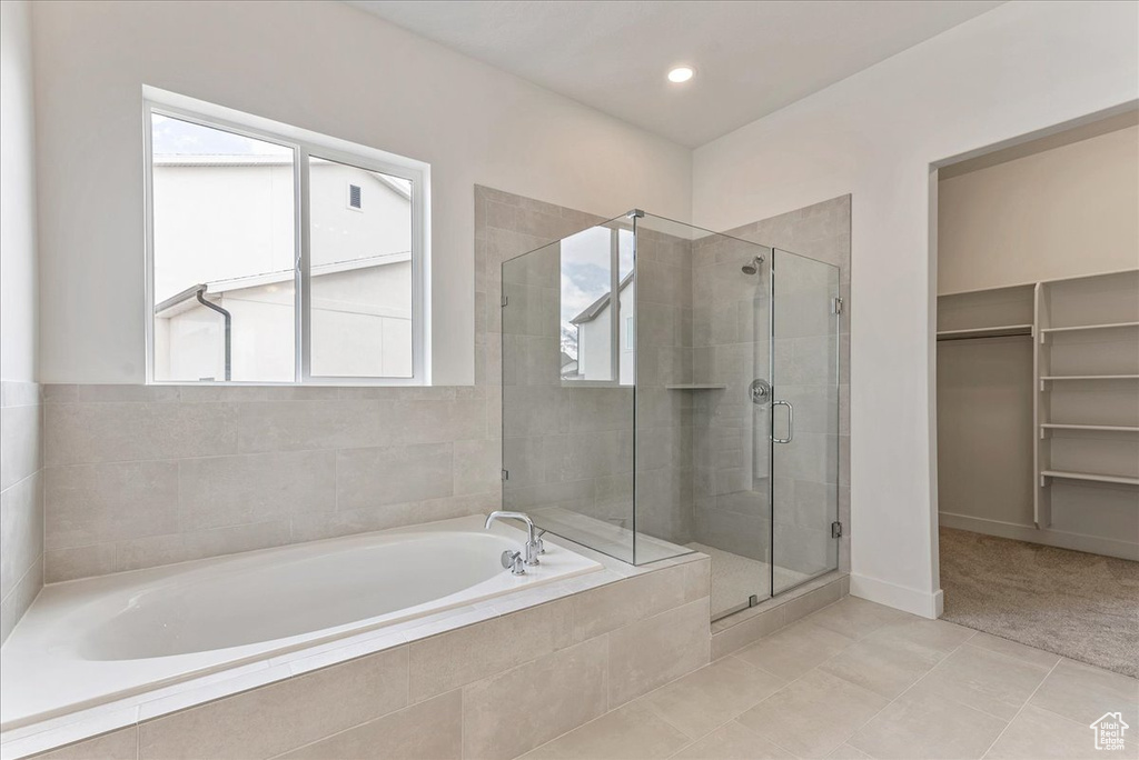 Bathroom featuring tile flooring and plus walk in shower