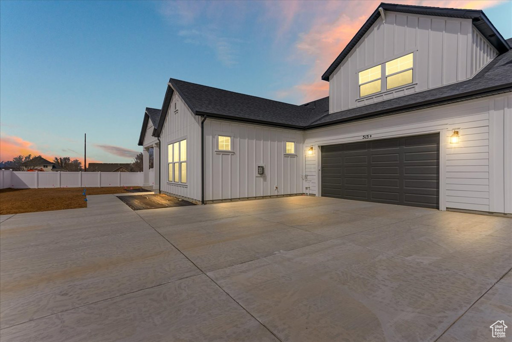 Property exterior at dusk featuring a garage