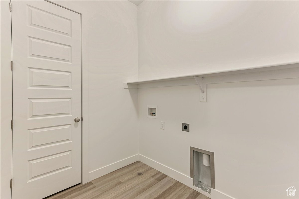 Washroom featuring hookup for an electric dryer, hookup for a washing machine, and light hardwood / wood-style flooring